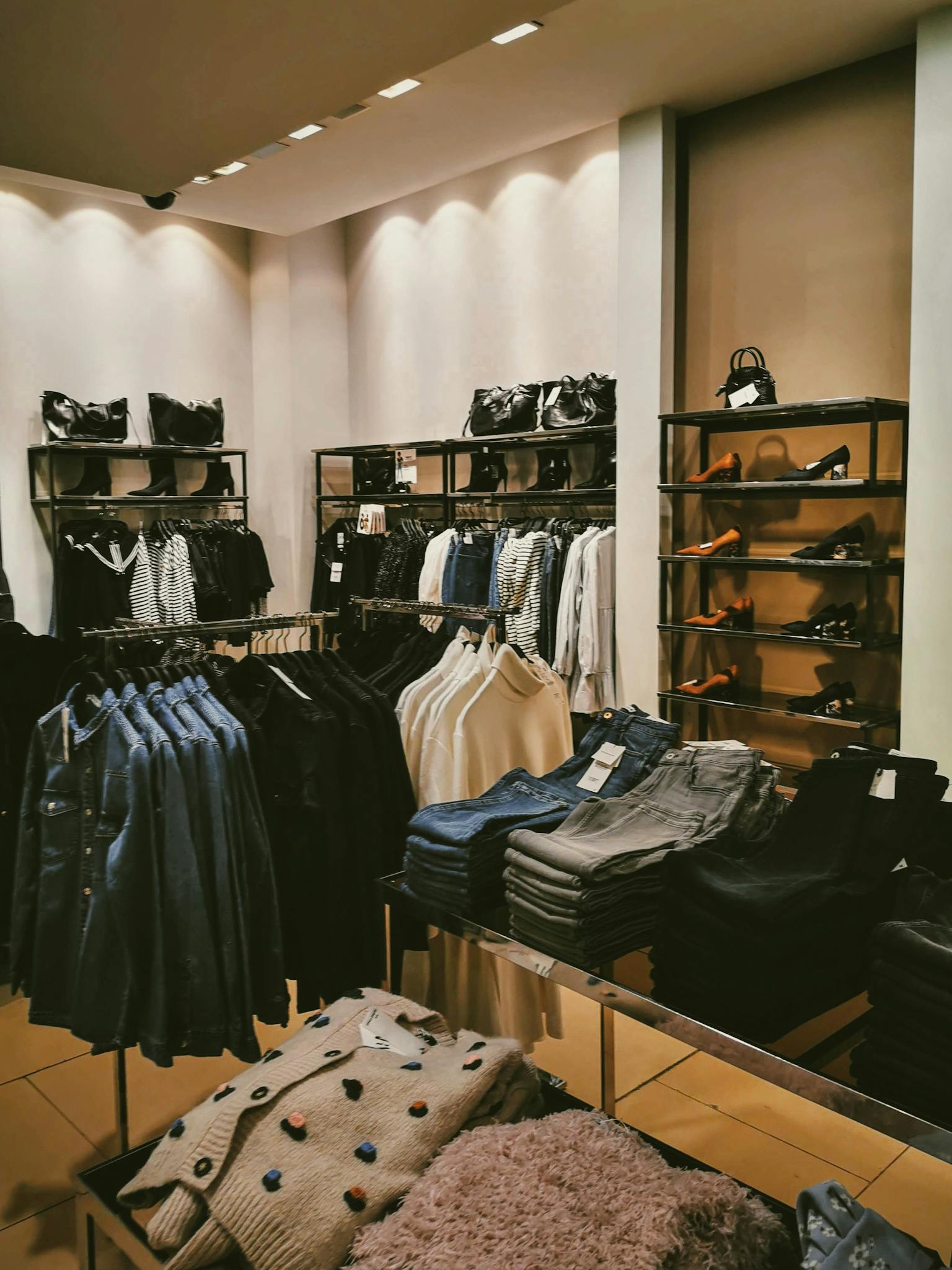 Stylish clothing store interior featuring a modern display of apparel and accessories.